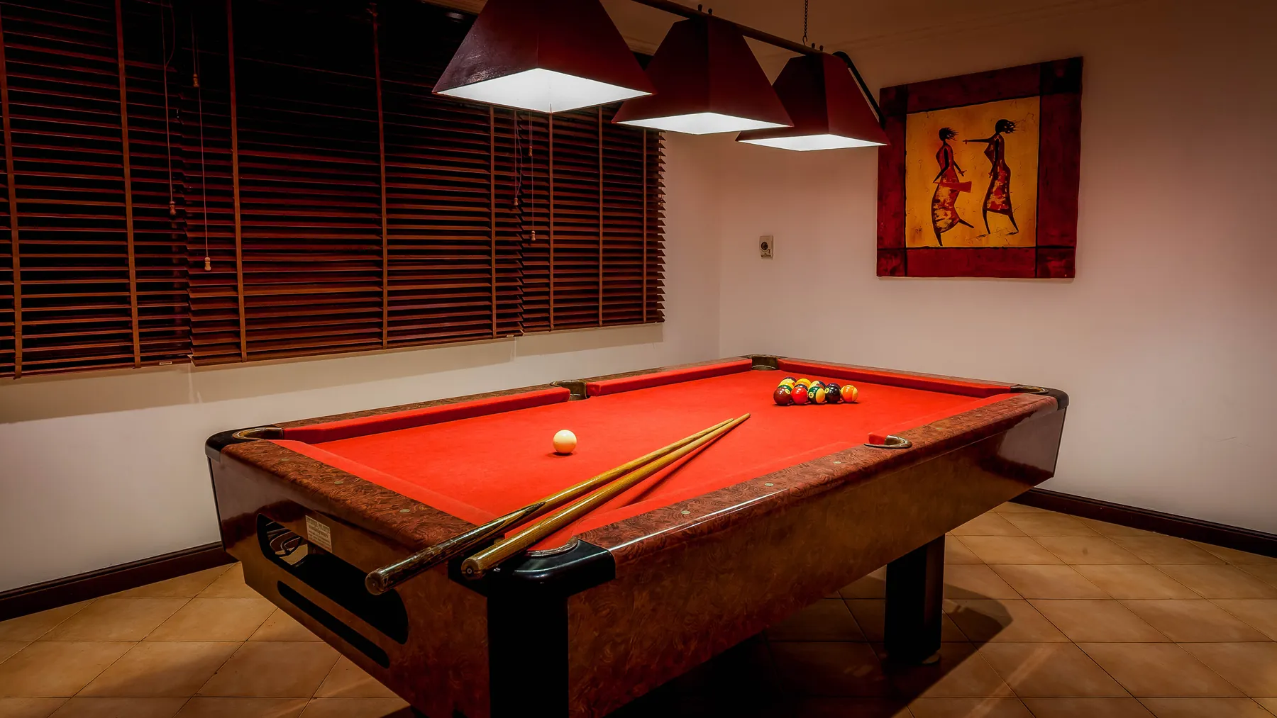 The American pool table in the games room at Villa Baan Paradise, under low pendant lights
