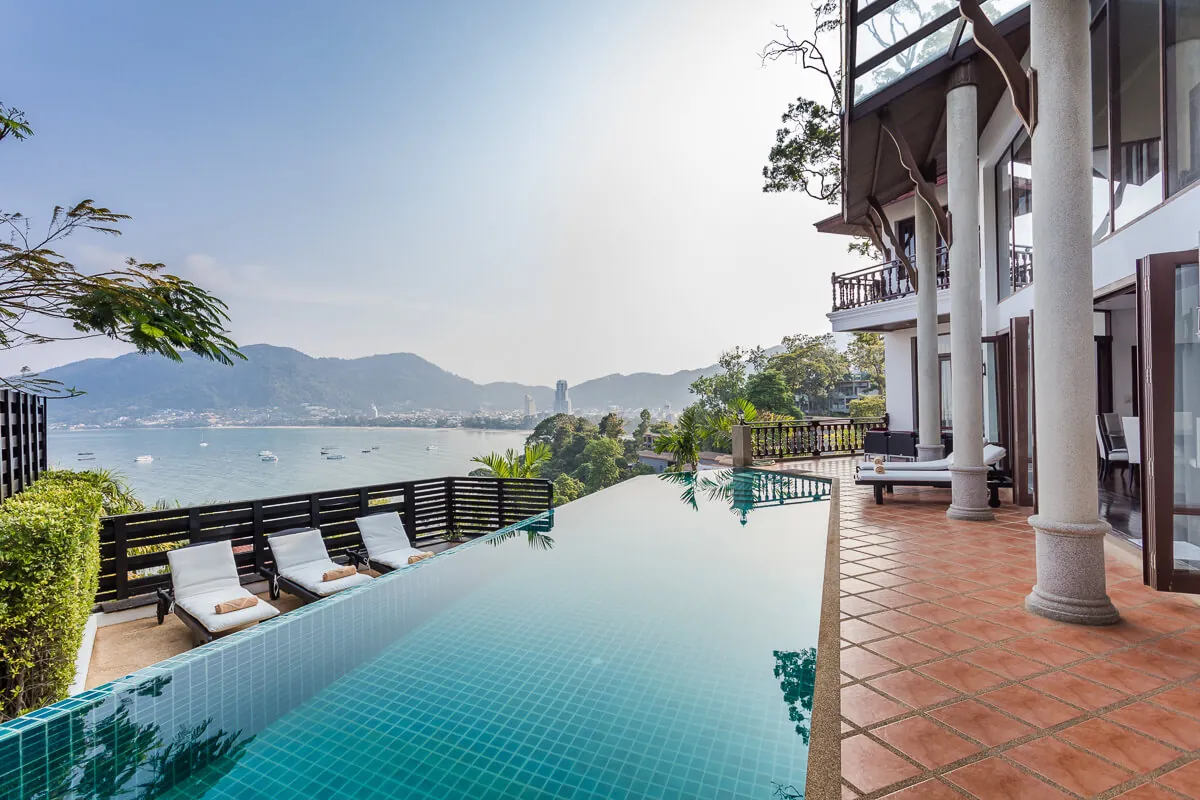 The pool deck at Villa Baan Paradise looking out past the headland to Patong Bay