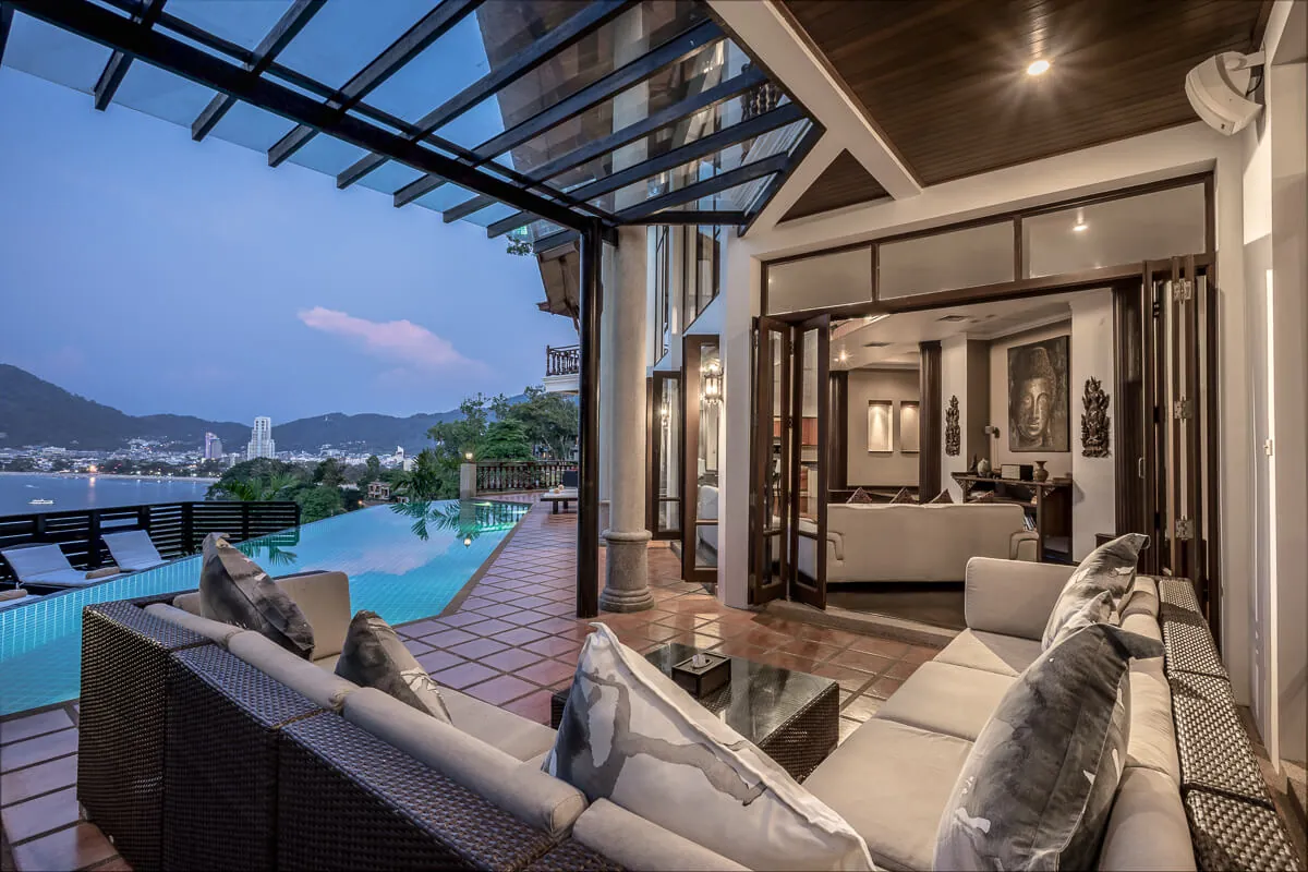 The shaded terrace lounge at Villa Baan Paradise, with daybeds looking over the pool to the bay